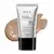 A imagem mostra um tubo de base líquida Make B. Glycolic. Ele é prateado, possui tampa preta e informações em letras pretas. Atrás da embalagem está a textura do produto, mostrando sua intensidade e a real cor da base.